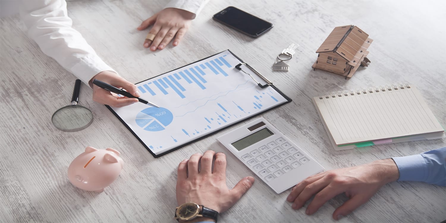 Real estate investors looking over investing data